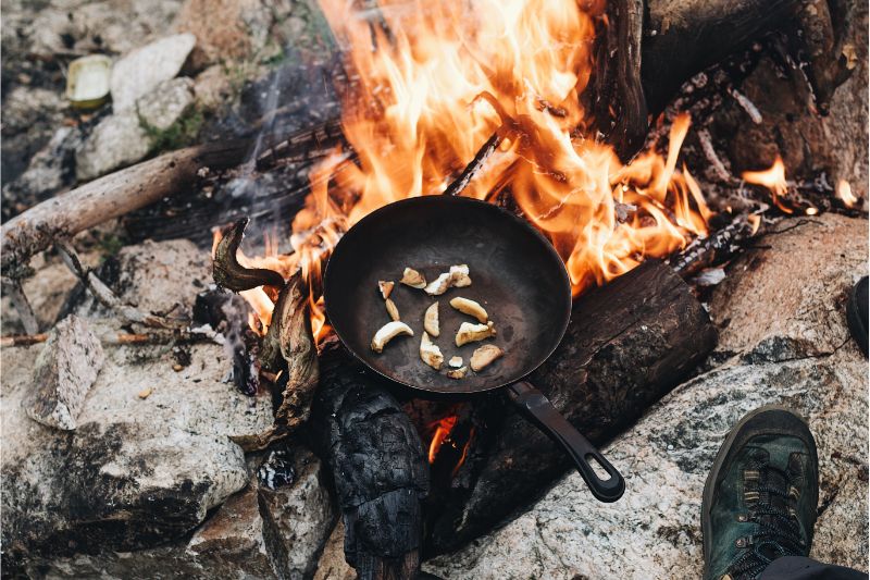 Persoon maakt vuur met behulp van vuursteen en staal tijdens een outdoor avontuur